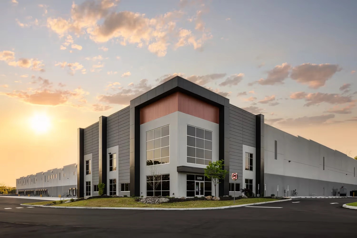 Modern industrial distribution facility at sunset
